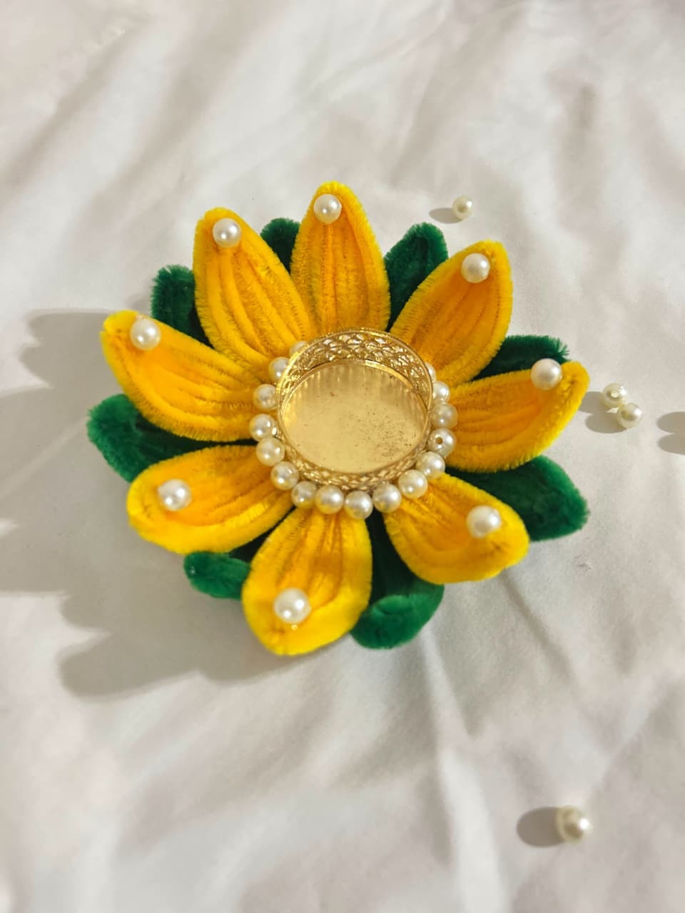 Beautiful handmade lotus-shaped diya holder crafted from colorful pipe cleaners.